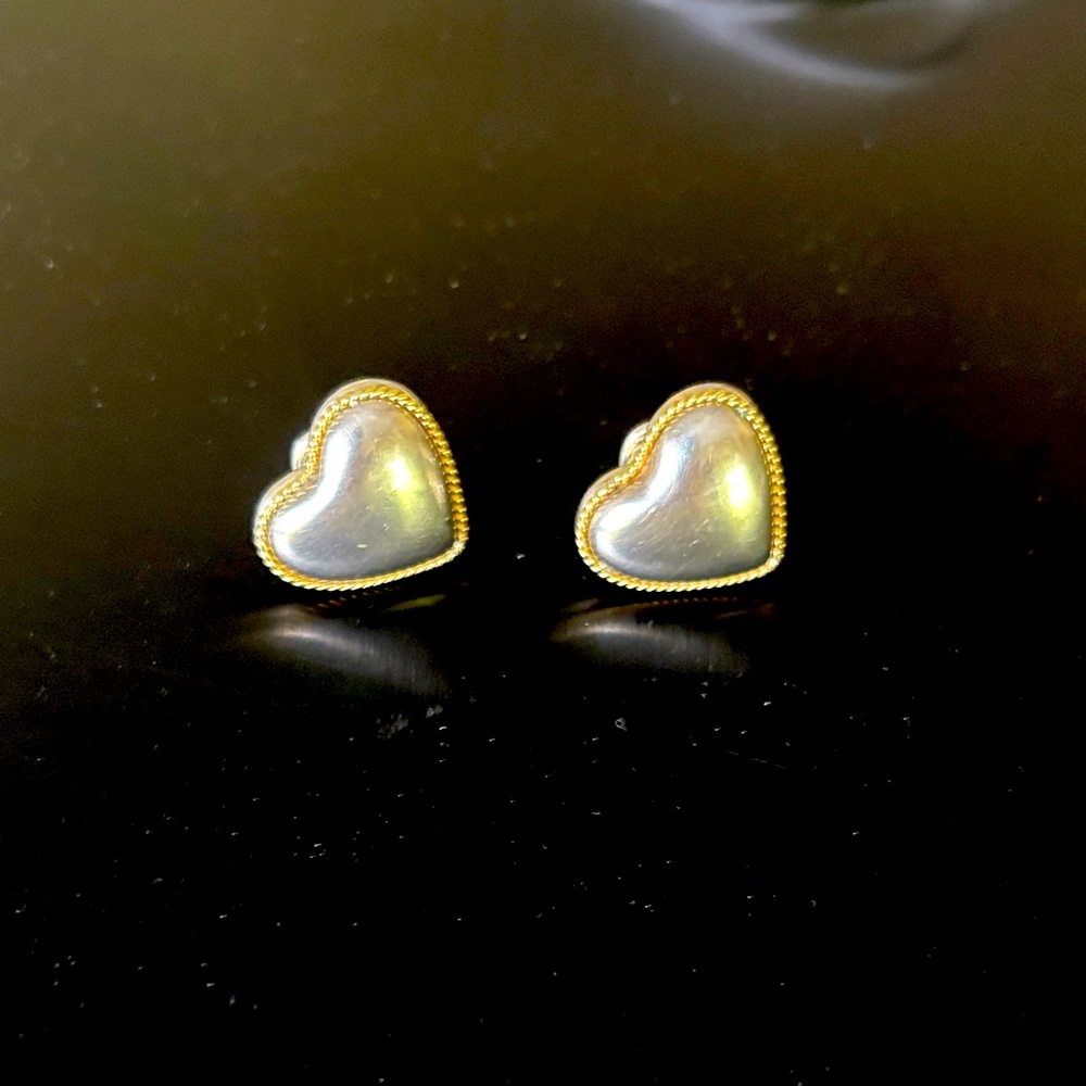 Tiffany and Company, Sterling, silver and 14 karat gold clip back earrings.